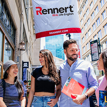 A diverse group of individuals standing together outside, engaged in conversation and enjoying the outdoors