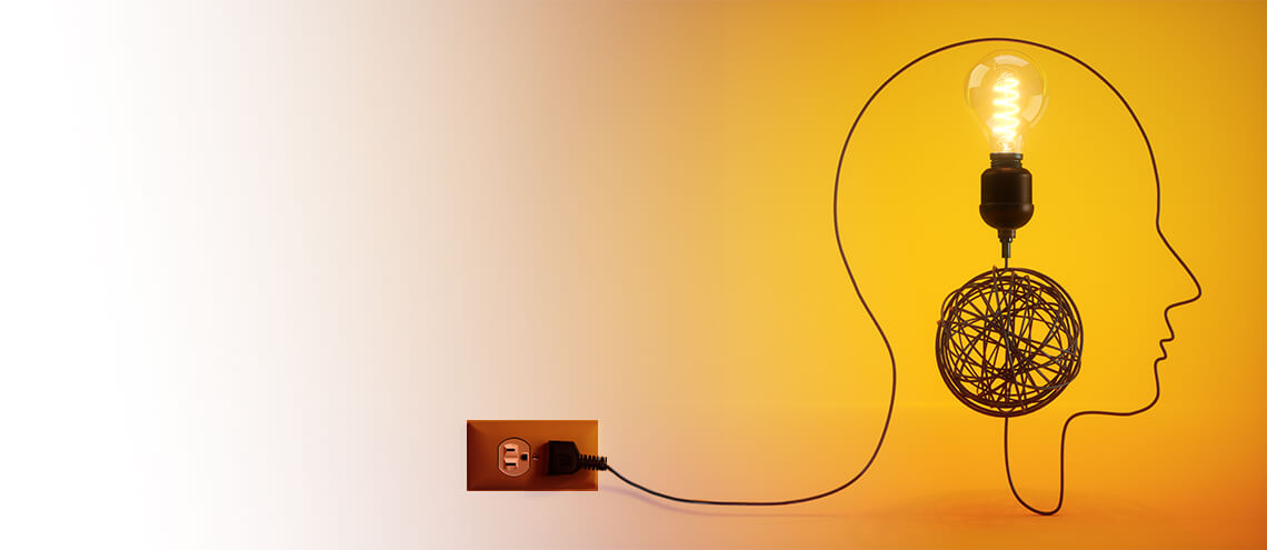 A wire with a light bulb inside a head, representing the concept of ideas and creativity