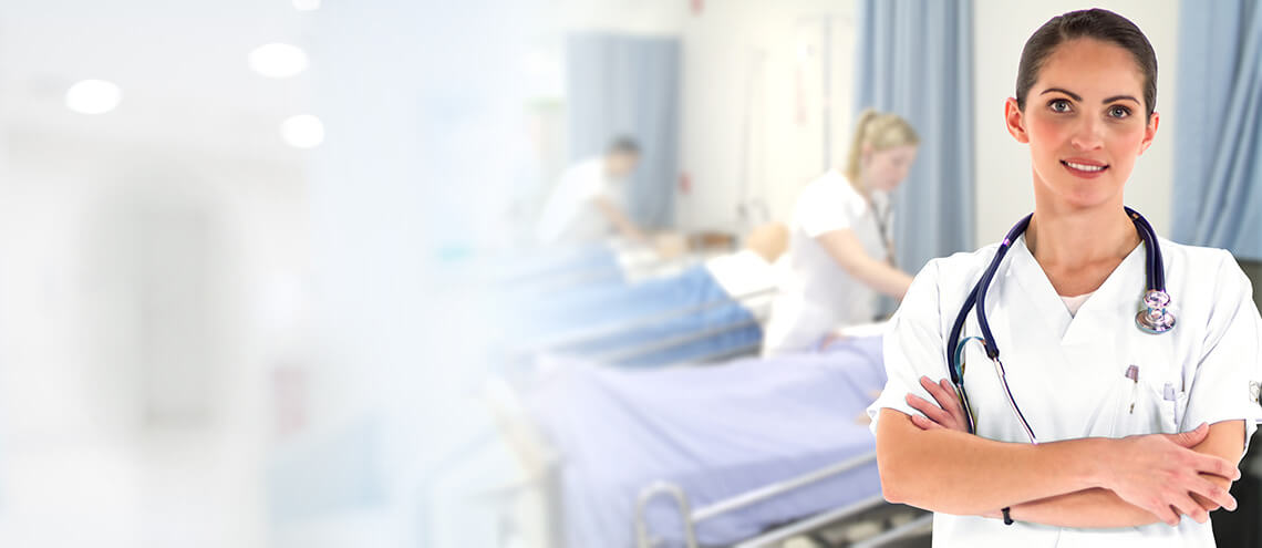 A healthcare professional stands confidently in a hospital setting, with patient beds and staff members in the background.