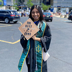 Brittany Ramsaran standing in graduation cap and gown
