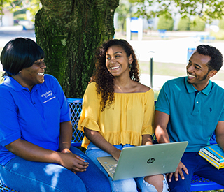 Image for mobile devices: Photo of the 3 Berkeley College at Woodland Park Campus sitting on a bench under a tree