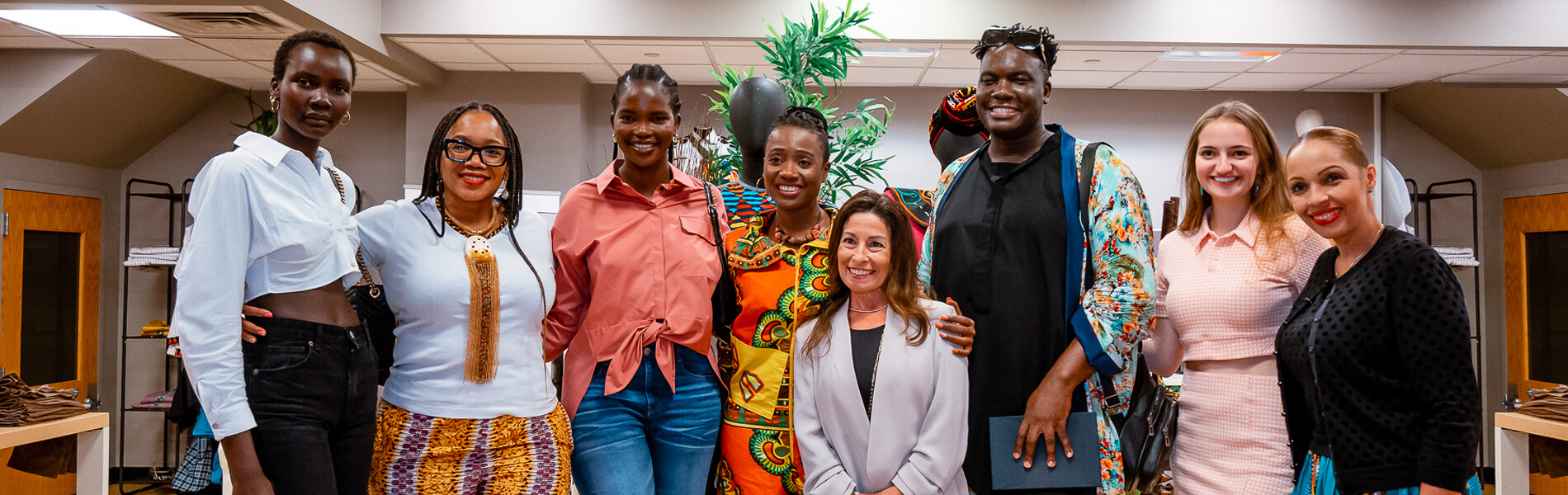 A diverse group of women standing together in a room, showcasing unity, empowerment, and camaraderie